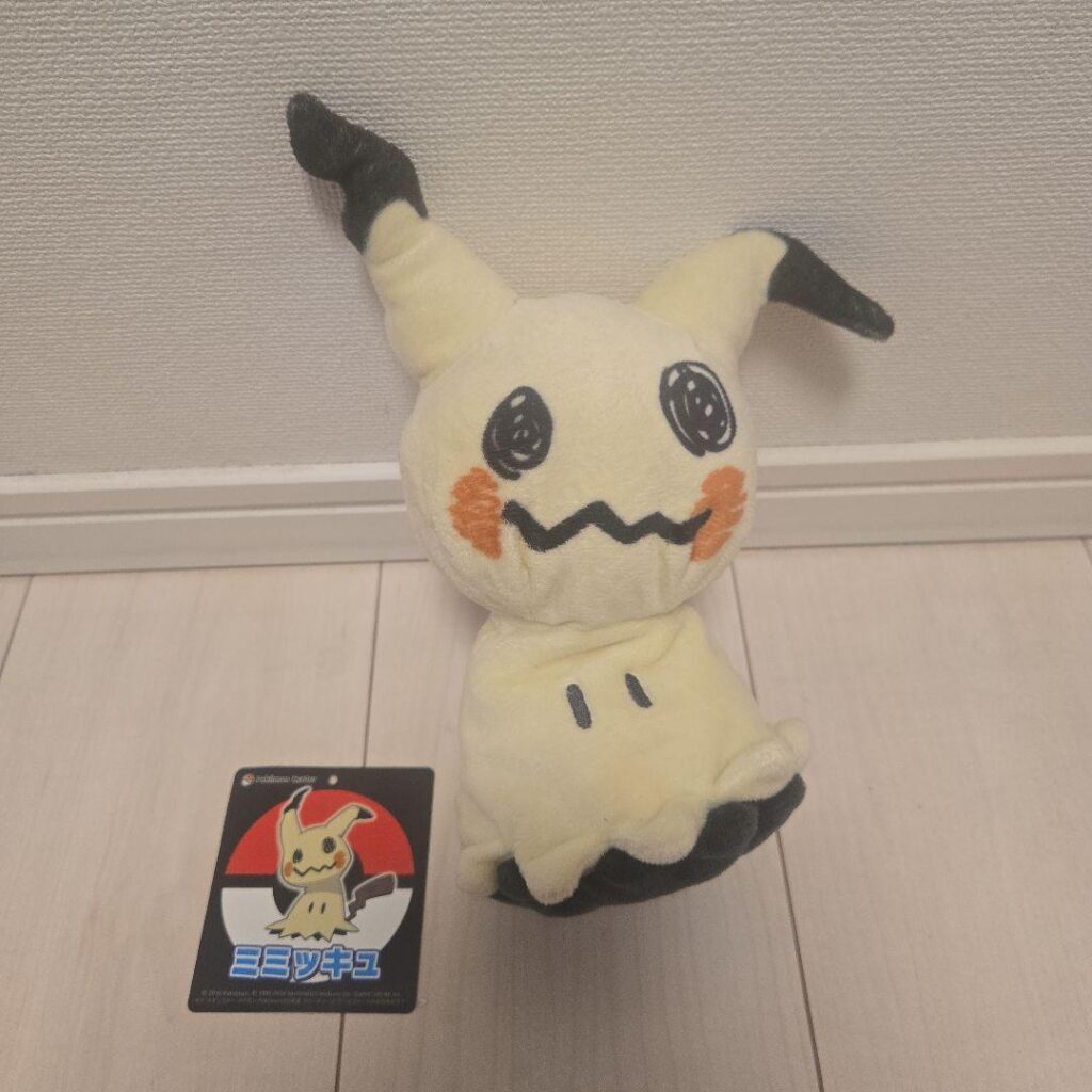 Mimikyu plush with a Pokémon Center tag